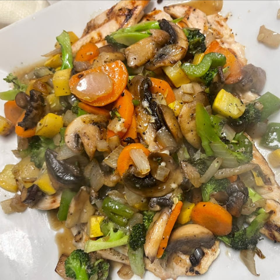 Grilled chicken breast topped with sautéed mushrooms, broccoli, carrots, onions, and yellow squash.